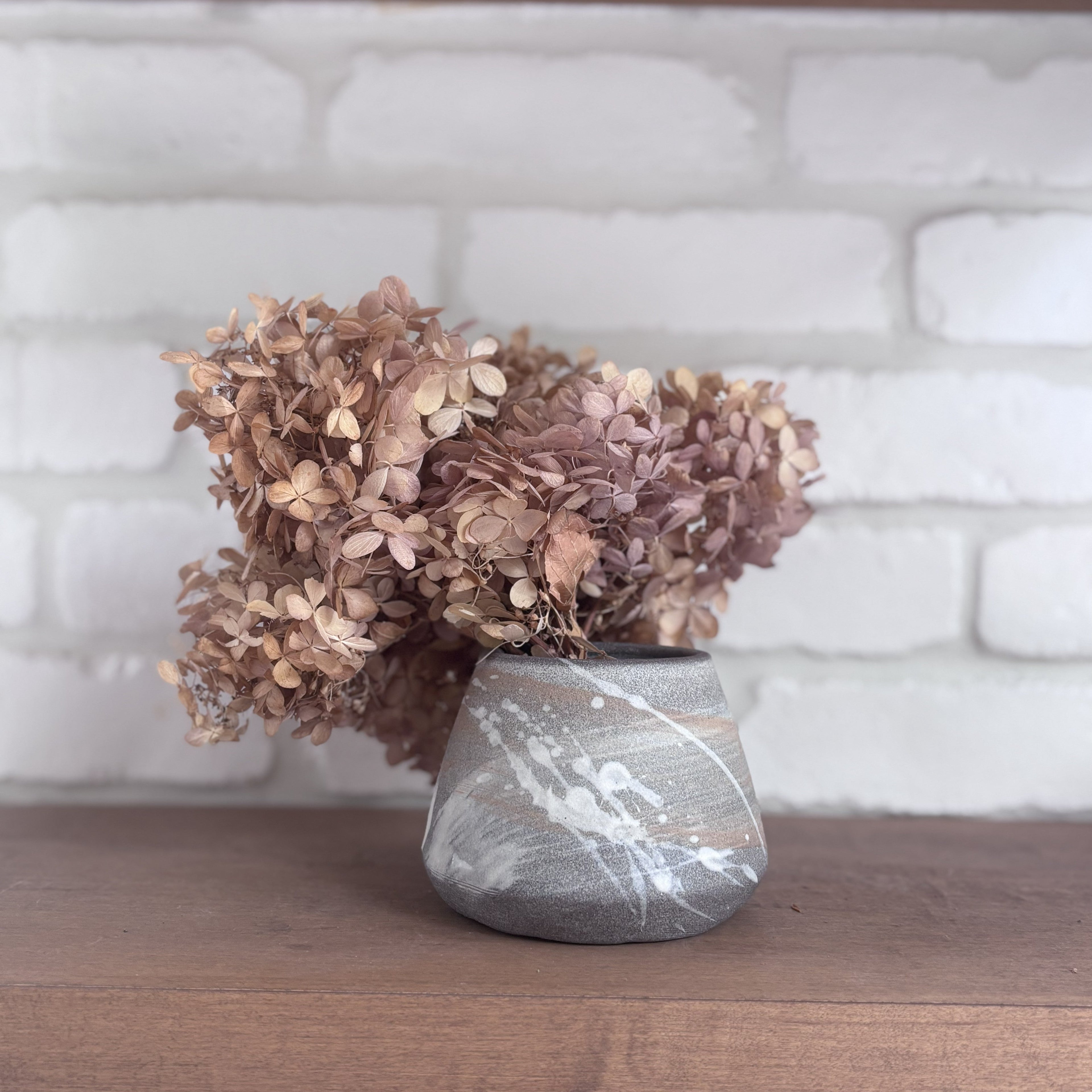 Small stone colored vase with japanese-inspired motifs